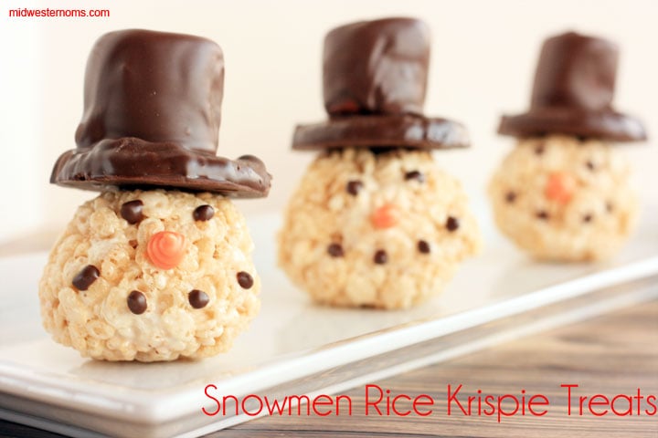 Snowmen Rice Krispie Treats. Rice Krispie Treats made into balls for snowmen heads. Top hats are made from shortbread cookies and large marshmallows covered in dark chocolate. 