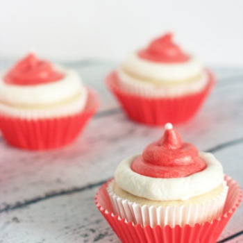 This Santa Hat Cupcakes Recipe is made with a doctored up cake mix, buttercream icing, and white sugar pearls. This doctored up cake mix recipe is the BEST!
