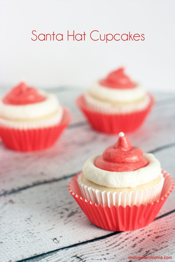 This Santa Hat Cupcakes Recipe is made with a doctored up cake mix, buttercream icing, and white sugar pearls. This doctored up cake mix recipe is the BEST!