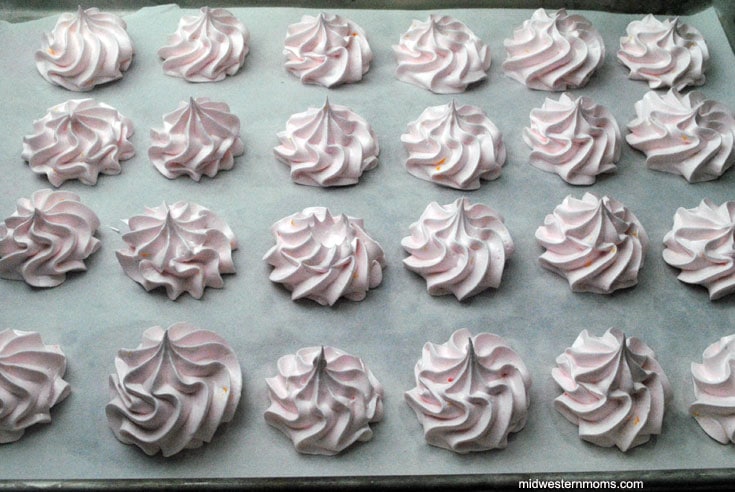 pipped peach meringues on baking sheet
