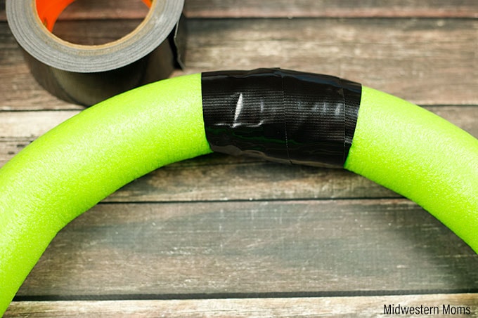 Use Gorilla Tape to tape the ends of the pool noodle to make a circle.