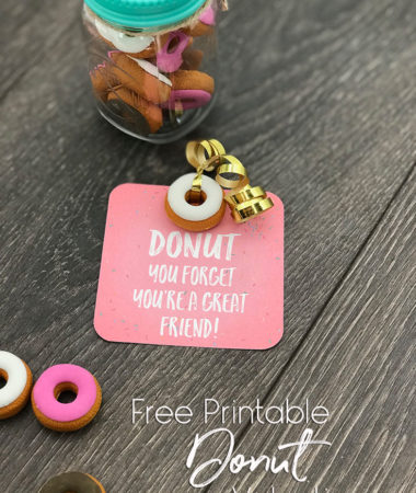 Printed Donut Valentine Card with a donut eraser attached with gold ribbon. Sitting next to a jar of donut erasers.
