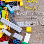 Legos laid on a wooden background. The words "Sticky Bricks? How to clean LEGOs like a Pro" overlaid on the photo.