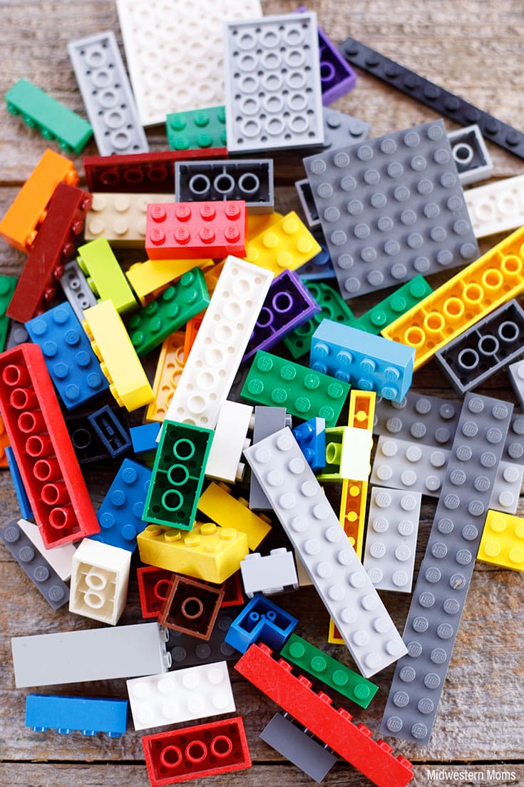 A pile of LEGOs on a wooden surface.