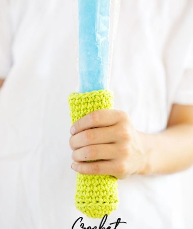 Child holding a Popsicle that has a crocheted popsicle koozie around it. Helps to keep hands from freezing while eating popsicles.