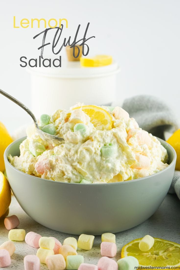 Lemon fluff salad recipe in a gray bowl with a spoon. 