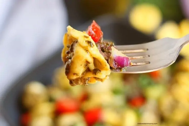 Close up of the summer pesto tortellini pasta salad on a fork.