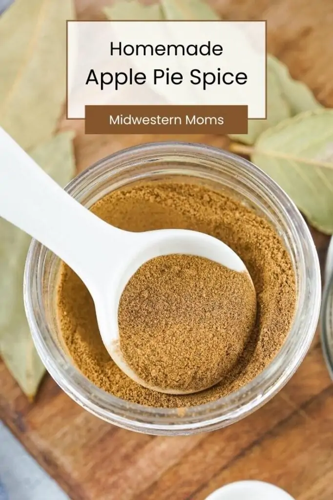 Apple Pie Spice in a Jar with a white measuring spoon.